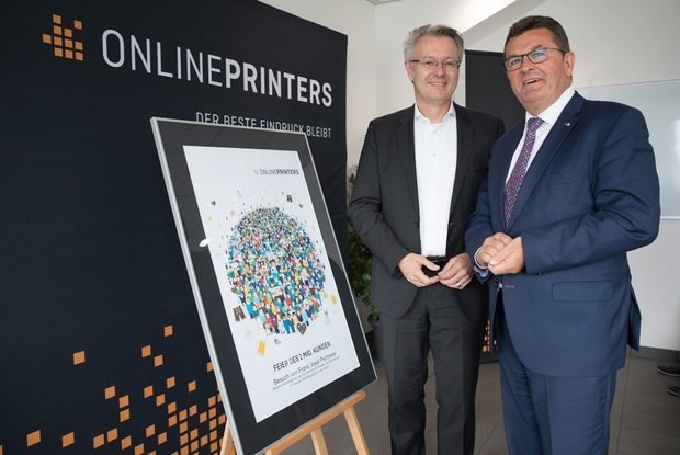Dr. Michael Fries (l.), CEO von Onlineprinters/diedruckerei.de, überreicht Auflage Eins des Kunstdrucks „Customer Globe“ an den Bayerischen Wirtschaftsminister.
